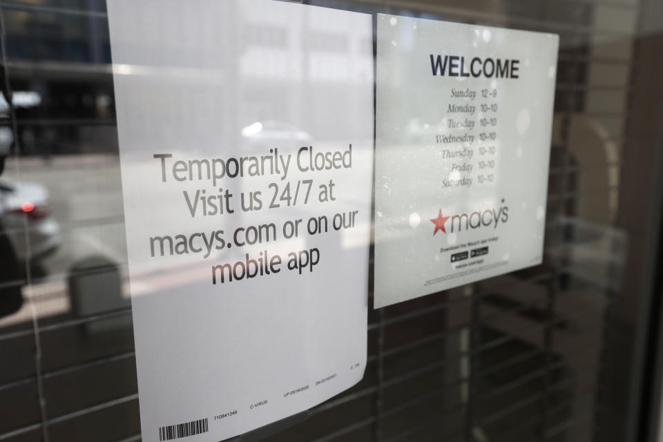 A closed sign is displayed on a window at a Macy's department, Monday, March 30, 2020, in Miami Beach, Fla. Macy's announced that they would furlough a majority of their 130,000 workers after their stores closed due to the virus outbreak. (AP Photo/Wilfredo Lee)
