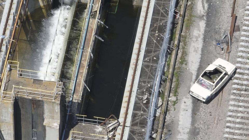 This photo taken from drone footage, provided by the Ukrainian military and dated May 28, 2023, shows a car on the Kakhovka Dam that appears to be laden with explosives. The dam collapsed June 6, while it was under Russian control. (Ukrainian military via AP)