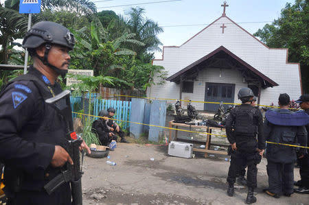 Police stand near the scene of an explosion outside a church in Samarinda, East Kalimantan, Indonesia November 13, 2016 in this photo taken by Antara Foto. Antara Foto/Amirulloh/ via REUTERS