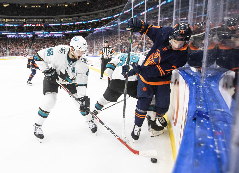 San Jose Sharks' Tomas Hertl (48) and Edmonton Oilers' Ryan McLeod (71) battle for the puck during second-period NHL hockey game action in Edmonton, Alberts, Thursday, April 28, 2022. (Jason Franson/The Canadian Press via AP)