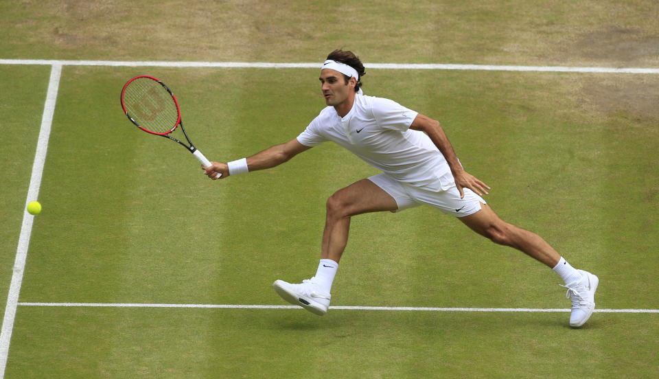 Roger Federer of Switzerland returns to Novak Djokovic of Serbia during the men's singles final at the All England Lawn Tennis Championships in Wimbledon, London, Sunday July 12, 2015. (Jonathan Brady/Pool Photo via AP)