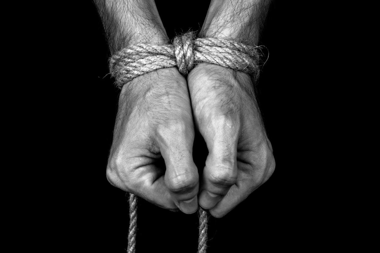 Hands tied with rope. (Photo: Getty Creative) 