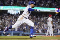 Los Angeles Dodgers' Mookie Betts rounds first after hitting a solo home run as Philadelphia Phillies relief pitcher Ranger Suarez stands on the mound during the seventh inning of a baseball game Tuesday, June 15, 2021, in Los Angeles. (AP Photo/Mark J. Terrill)