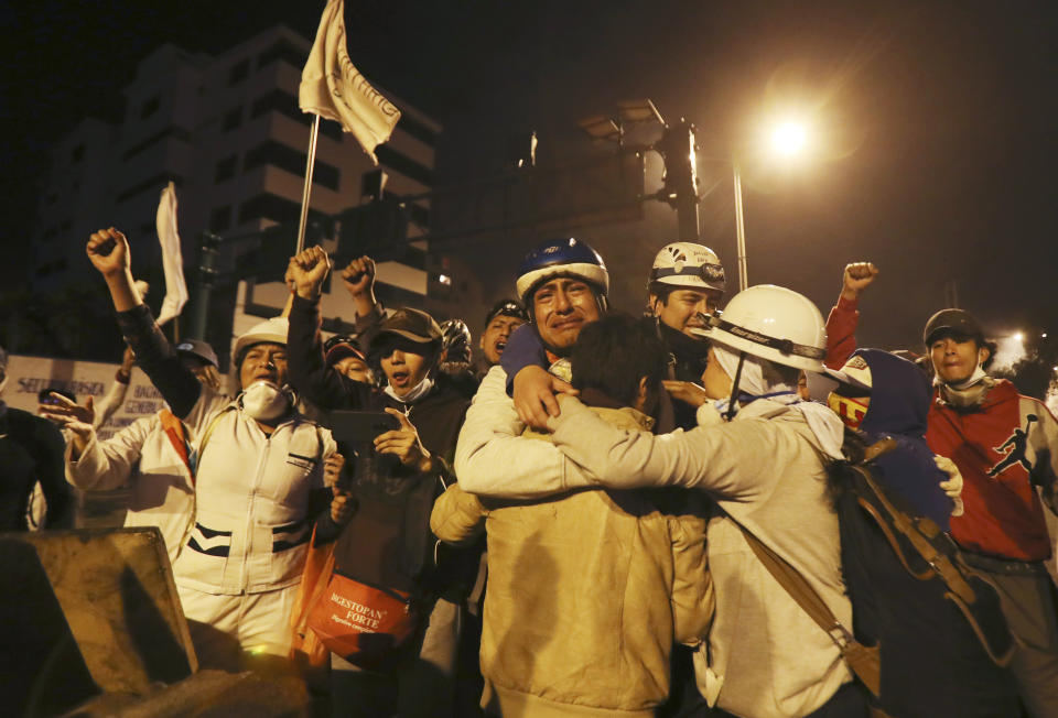 Protesters celebrate the announcement that the government cancelled an austerity package that triggered violent protests, in Quito, Ecuador, Sunday, Oct. 13, 2019. Ecuadorian President Lenin Moreno and leaders of the country's indigenous peoples have struck a deal to cancel the disputed austerity package and end nearly two weeks of protests that have paralyzed the economy and left several people dead. (AP Photo/ Dolores Ochoa)