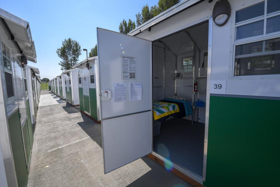 A tiny home, a temporary housing unit for people who are experiencing homelessness, is part of the Tarzana Tiny Home Village in Los Angeles. The tiny homes are small prefabricated houses installed in a parking lot.