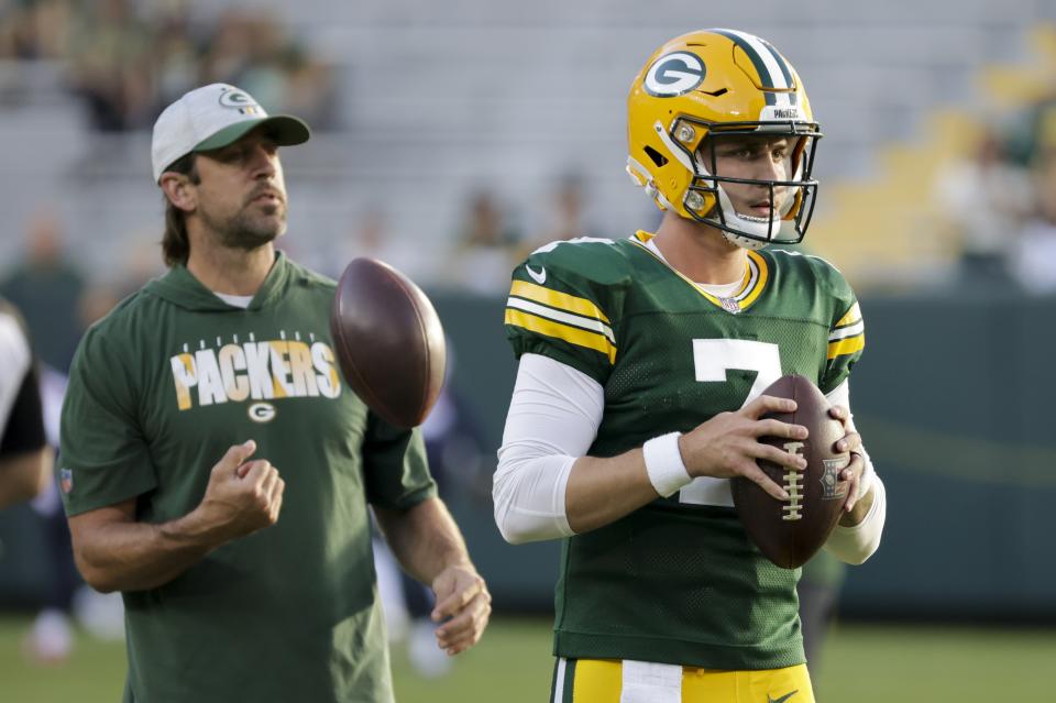 Green Bay Packers' Aaron Rodgers watches as Kurt Benkert warms up before a preseason NFL football game against the Houston Texans Saturday, Aug. 14, 2021, in Green Bay, Wis. (AP Photo/Mike Roemer)