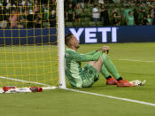 Austin FC goalkeeper Brad Stuver sits against the goal after a loss to the San Jose Earthquakes in an MLS soccer match, Saturday, Sept. 18, 2021, in Austin, Texas. (AP Photo/Michael Thomas)