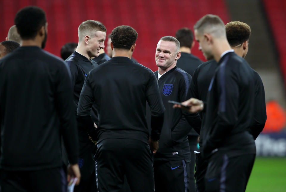 Rooney shares a pre-match joke with his team-mates (Nick Potts/PA)