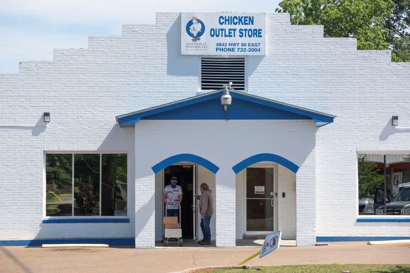 Una persona saca cajas de Chicken Outlet Store, ya que el brote de la enfermedad del coronavirus (COVID-19) continúa en Morton, Mississippi, EEUU.