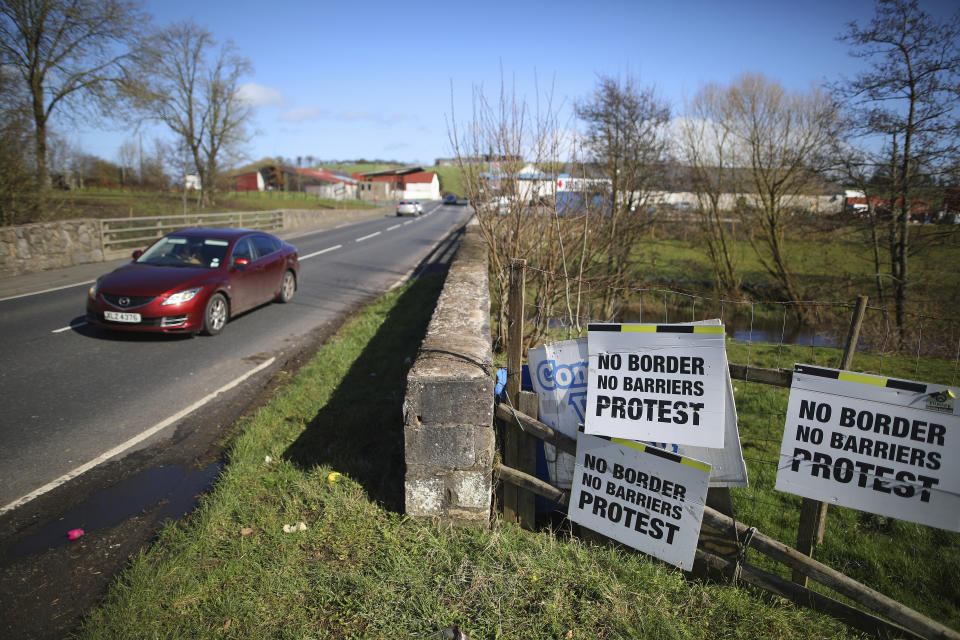 FILE - In this file photo dated Tuesday, March, 12, 2019, a Motorist crosses the Irish border in Middletown, Northern Ireland. The hope of Britain's Brexit split from the European Union depends on finding a political solution to avoid having a hard border across the peaceful green fields that span the seamless border dividing Britain's Northern Ireland from Europe's Republic of Ireland. (AP Photo/Peter Morrison, FILE)