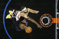 Philadelphia 76ers' Joel Embiid, bottom, goes up for a shot against Cleveland Cavaliers' JaVale McGee during the first half of an NBA basketball game, Saturday, Feb. 27, 2021, in Philadelphia. (AP Photo/Matt Slocum)