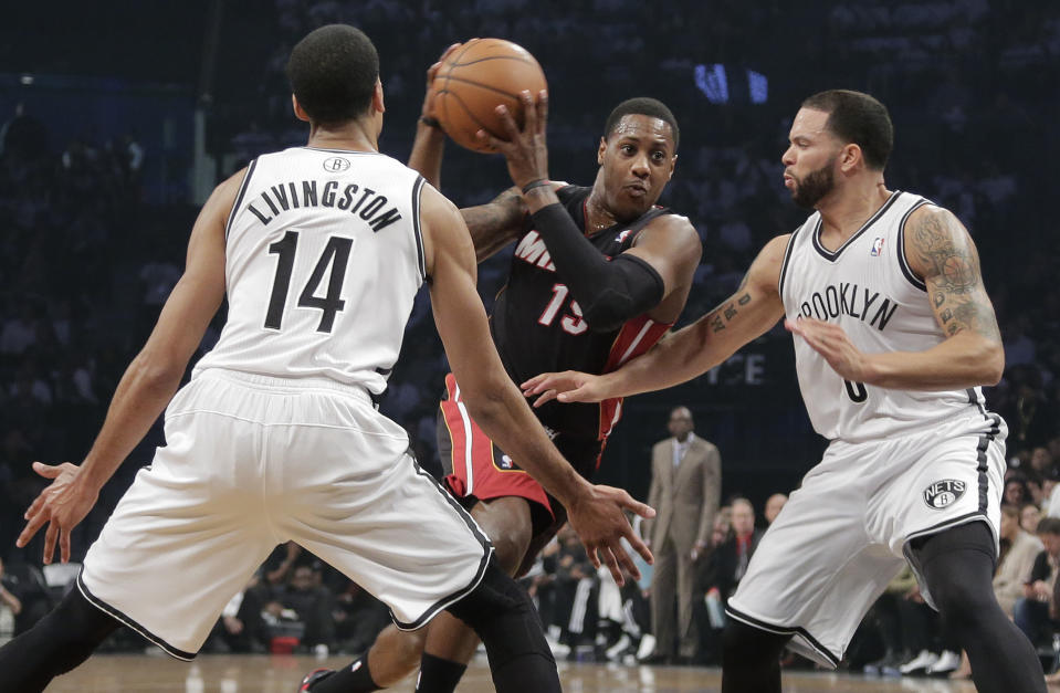 Miami Heat guard Mario Chalmers (15) drives against Brooklyn Nets guards Shaun Livingston (14) and Deron Williams (8) in the second period during Game 3 of an Eastern Conference semifinal NBA playoff basketball game on Saturday, May 10, 2014, in New York. (AP Photo/Julie Jacobson)