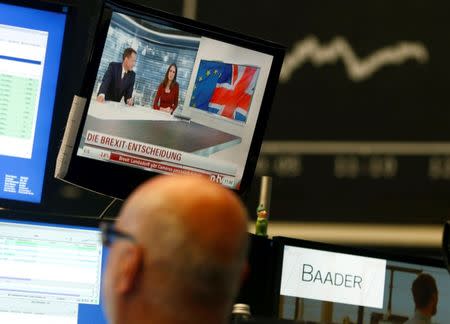 A news broadcast on a TV is pictured in front of the German share price index DAX board, at the stock exchange in Frankfurt, Germany, June 24, 2016, after Britain voted to leave the European Union in the EU BREXIT referendum. REUTERS/Ralph Orlowski