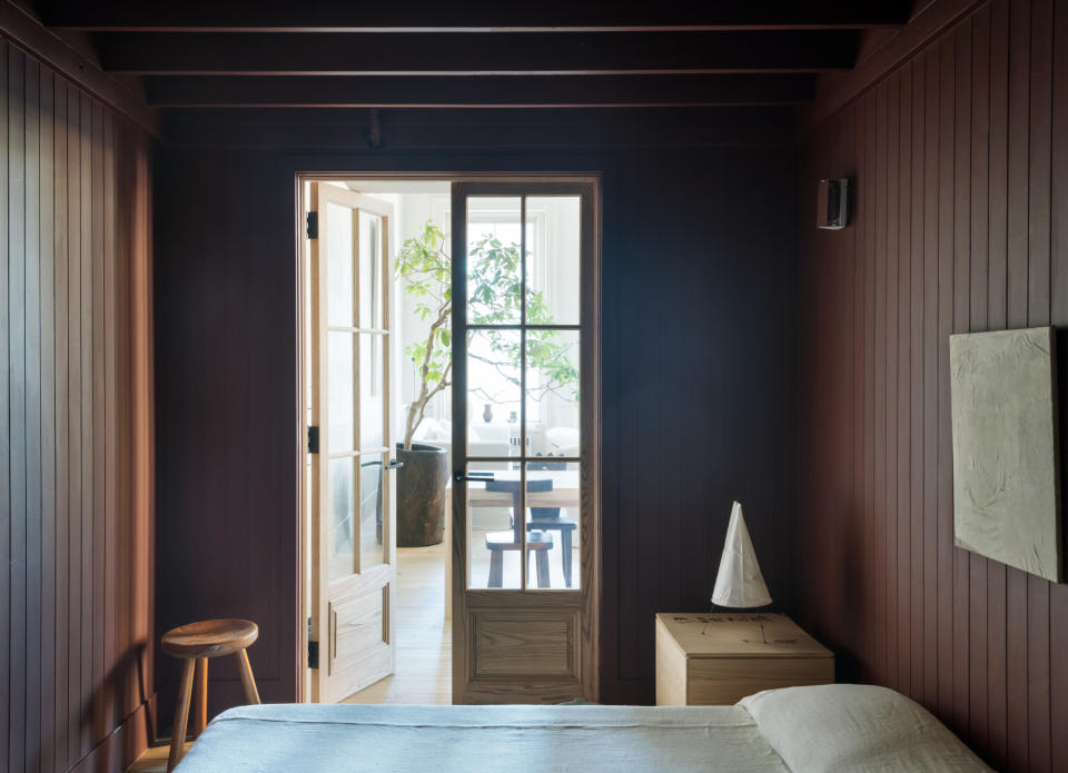 Small bedroom with maroon cladded walls