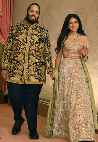 <p>SUJIT JAISWAL/AFP via Getty</p> Anant Ambani and Radhika Merchant at their sangeet ceremony in Mumbai, India, on July 5, 2024