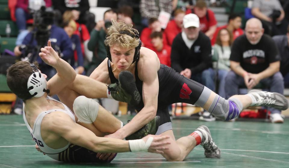 Wadsworth's Jaxon Joy drives North Royalton's Luke Koprowski to the mat during the championship match in 150 lbs. weight class at the 2024 Suburban League tournament at Highland High School in Medina on Saturday, Jan. 27, 2024.