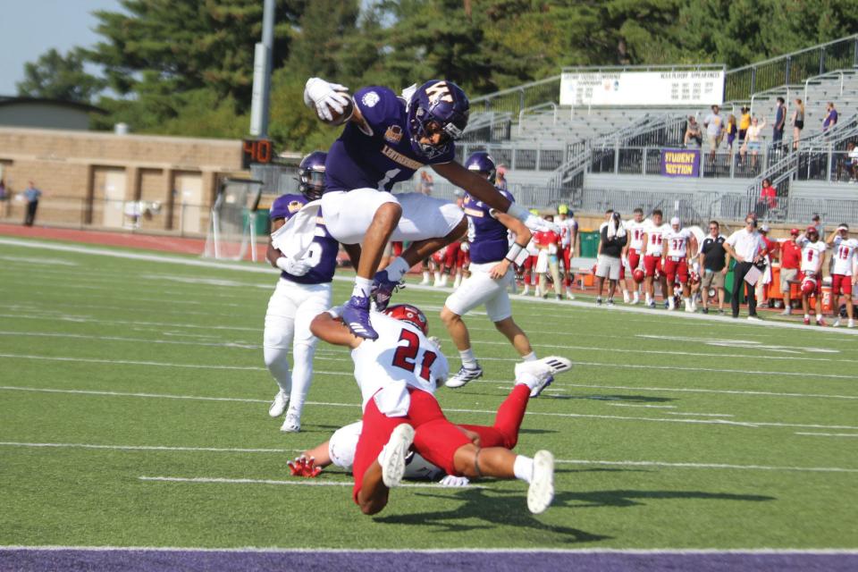 Tony Tate hurdles a defender for a touchdown.