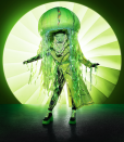 <p><strong>Clues:</strong></p><p>1) In a promo video, Jellyfish mentions jelly, jam, and marmalade.</p><p>2) Jellyfish wears 3-inch platform boots that are patent black and neon green.</p><p>3) Jellyfish says that even though its cold blooded, it has “a warm and glowing flow with H2O.”</p><p><strong>Top Predictions: </strong>Trinity Fatu, Marsai Martin, McKayla Maroney</p>