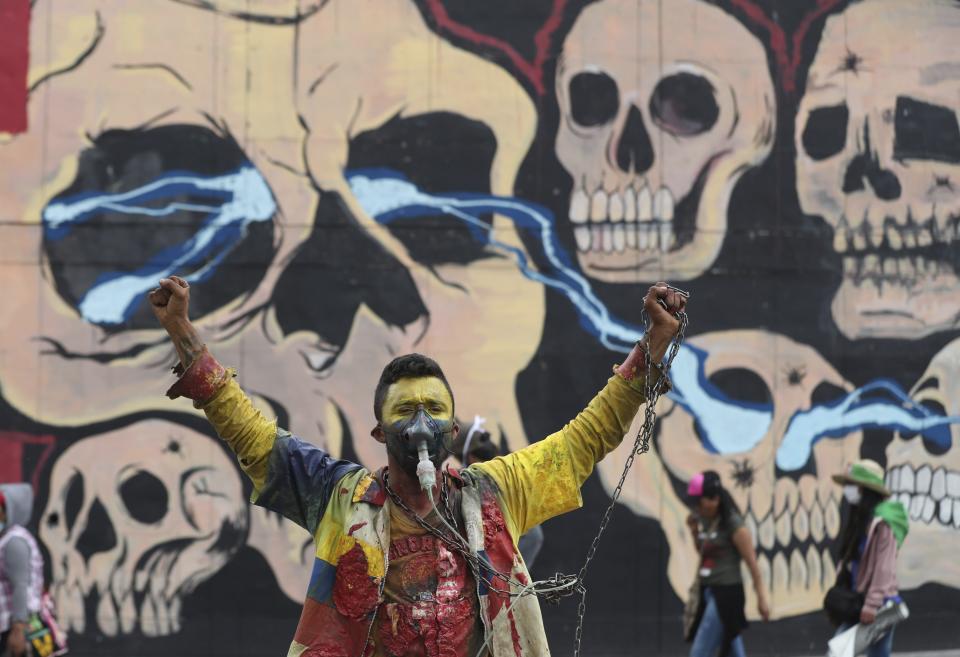 A man attends a march organized by Indigenous communities to protest the government in Bogota, Colombia, Monday, Oct. 19, 2020. The leaders of Indigenous communities say they are mobilizing to reject massacres, assassinations of social leaders, criminalization of social protest, to defend their territory, democracy and peace, and plan to stay in the capital for a nationwide protest and strike on Oct. 21. (AP Photo/Fernando Vergara)