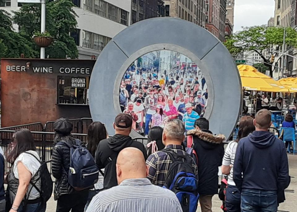 Crowds around the NYC Portal look at people in Dublin. The Portal reopened this week. Photo Credit: Flatiron NoMad Partnership