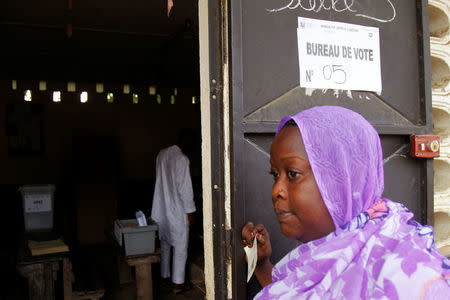 A woman waits to cast her vote at a polling station during a referendum on a new constitution, in Abidjan, Ivory Coast October 30, 2016. REUTERS/Luc Gnago