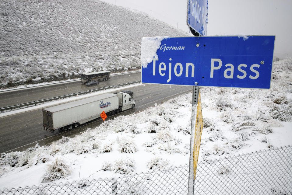 Snow falls along the Interstate 5 freeway at the Tejon Pass as travelers try to get in and out of Southern California for the Thanksgiving holiday, Wednesday, Nov. 27, 2019. Plows were running and CHP was guiding traffic in an attempt to keep the freeway open as long as possible.(David Crane/The Orange County Register via AP)