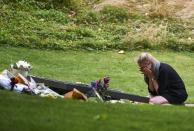 A woman cries at the memorial plaque in London's Hyde Park on July 7, 2015