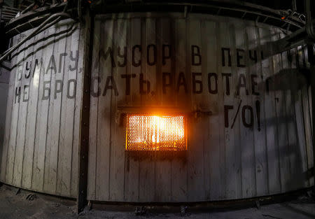 A melting furnace is seen inside Eurasian Resources Group's (ERG) Aksu Ferroalloys Plant in the town of Aksu, north-eastern Kazakhstan, February 19, 2018. The sign reads: "Do not throw paper, rubbish into the furnace, gas cleaning works!" REUTERS/Shamil Zhumatov