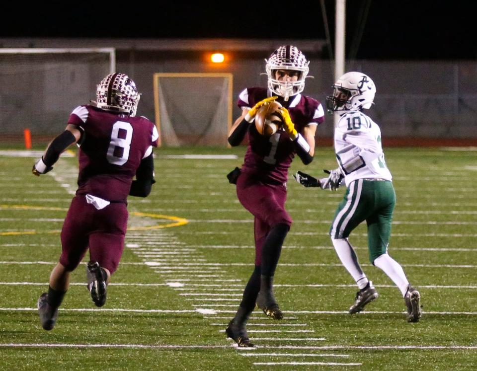 Caravel's Christian DeRegis snags his third interception of the game in the fourth quarter of the Bucs' 30-6 win against Archmere in the semifinals of the DIAA Class 2A state tournament Friday at Bob Peoples Stadium.