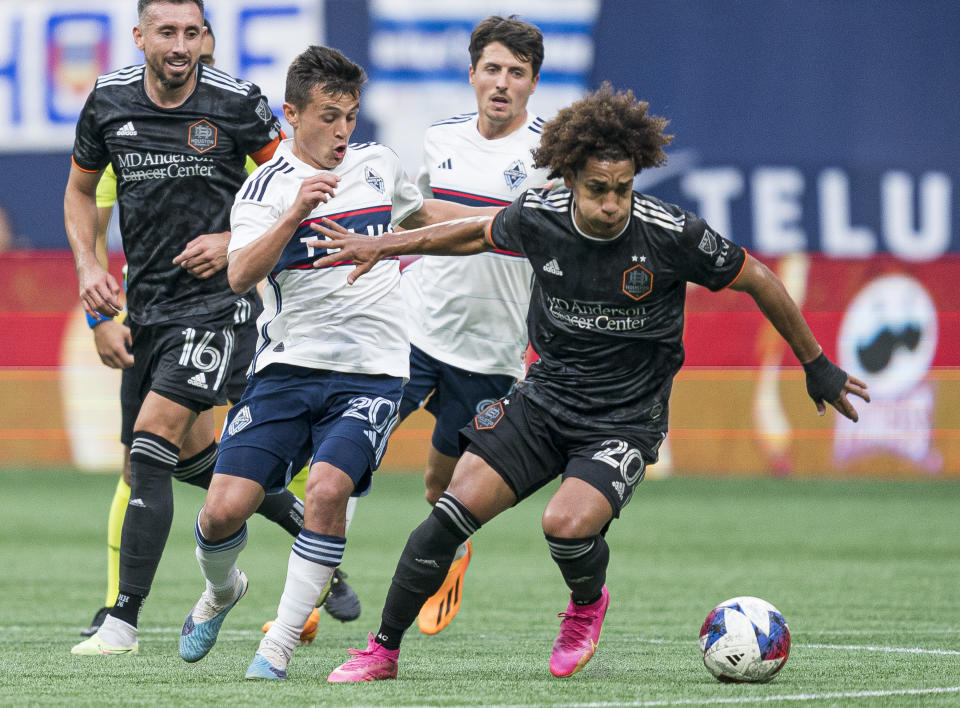 Houston Dynamo's Coco Carrasquilla, right, tries to break away from Vancouver Whitecaps' Andres Cubas during the first half of an MLS soccer match Wednesday, May 31, 2023, in Vancouver, British Columbia. (Rich Lam/The Canadian Press via AP)