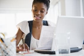 Black woman paying bills online