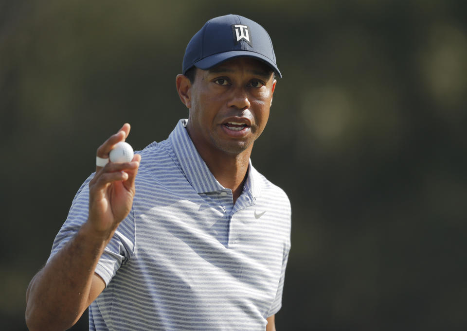 Tiger Woods holds up his golf ball after putting out on the 14th hole during the second round of The Players Championship golf tournament Friday, March 15, 2019, in Ponte Vedra Beach, Fla. (AP Photo/Gerald Herbert)