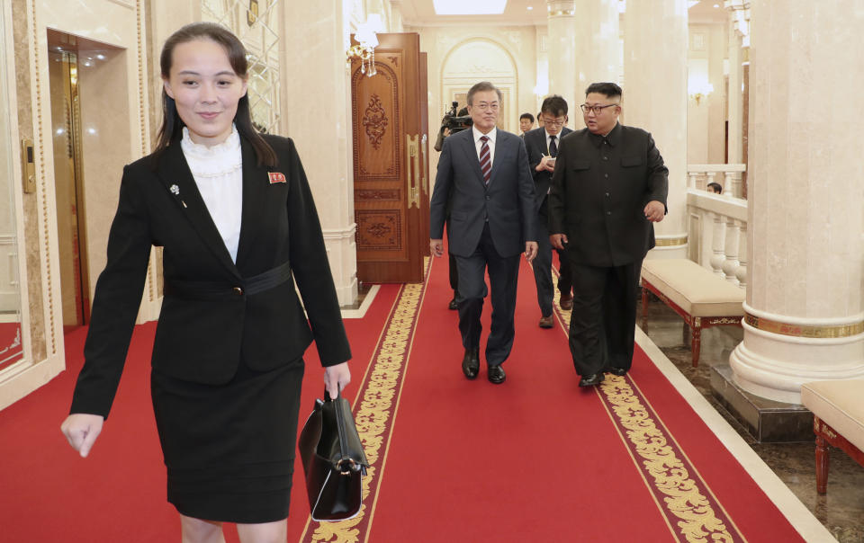 FILE - In this Sept. 18, 2018, file photo, Kim Yo Jong, left, sister of North Korean Leader, walks ahead of South Korean President Moon Jae-in and North Koran leader Kim Jong Un, right, arrive at the headquarters of the Central Committee of the Workers' Party in Pyongyang, North Korea. In her first known official statement Tuesday, March 3, 2020, Kim's younger sister leveled diatribes and insults against rival South Korea for protesting her country's latest live-fire exercises.(Pyongyang Press Corps Pool via AP, File)