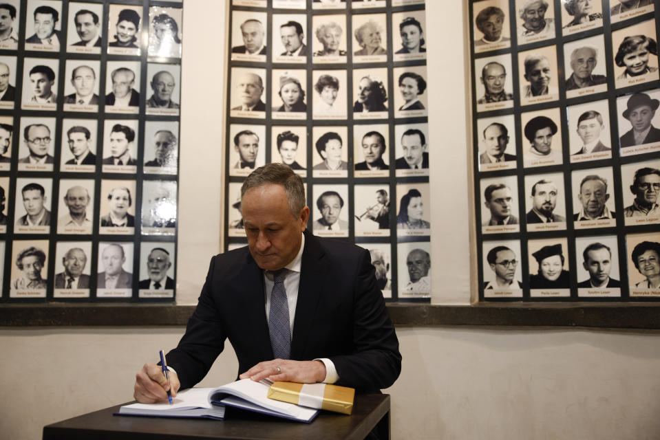 U.S. Second Gentleman, Douglas Emhoff, signs a guest book as he visits to the Oskar Schindler Enamel Factory Museum in Krakow, Poland, Saturday, Jan. 28, 2023. (AP Photo/Michal Dyjuk)