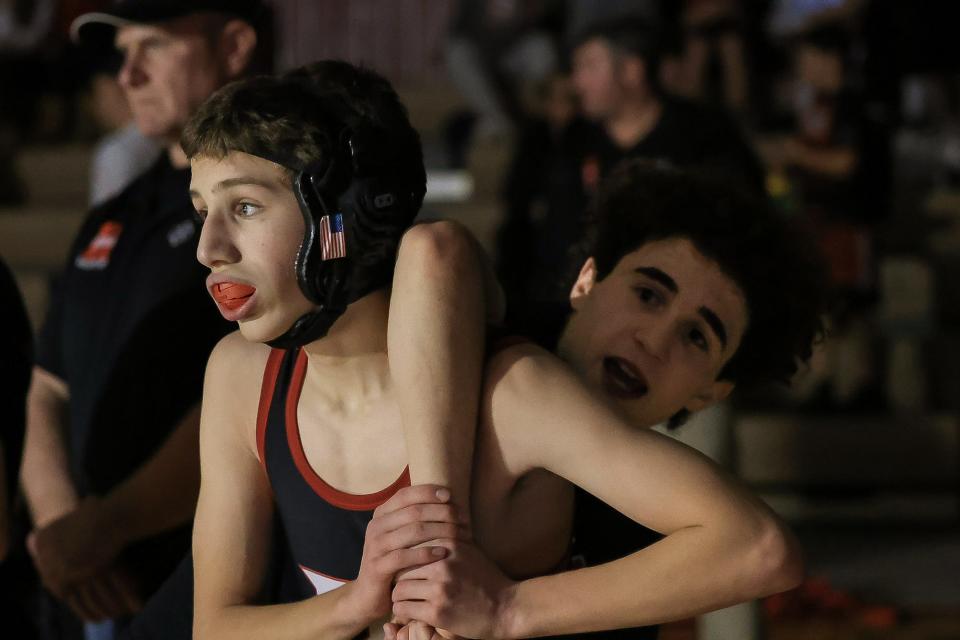Brothers Zak Robinson (right) and Nate Robinson practice a move before Nate's wrestling match against Bellingham at Holliston High School on Jan. 10, 2024.