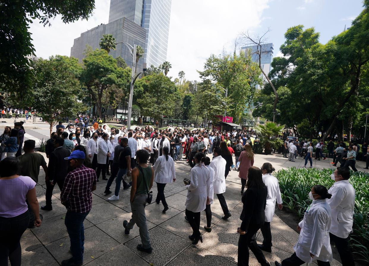 People walk to a meeting point on Paseo de la Reforma avenue as part of an earthquake simulation drill held to mark the anniversary of two past, deadly quakes in Mexico City, Monday, Sept. 19, 2022. Alarms for a real, 7.6 magnitude quake came less than an hour after this drill. 