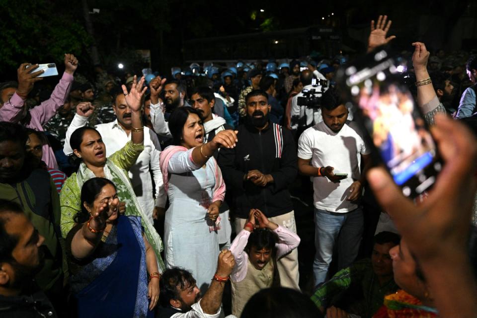 Supporters of the Aam Aadmi Party shout slogans outside in front of the home of Aam Aadmi Party chief and Delhi Chief Minister Arvind Kejriwal after he was arrested (AFP via Getty Images)