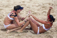 (L-R) Kerri Walsh and Misty May-Treanor of the United States celebrate winning match point against Wang Jie and Tian Jia of China in the women's beach volleyball gold medal match held at the Chaoyang Park Beach Volleyball Ground during Day 13 of the Beijing 2008 Olympic Games on August 21, 2008 in Beijing, China.