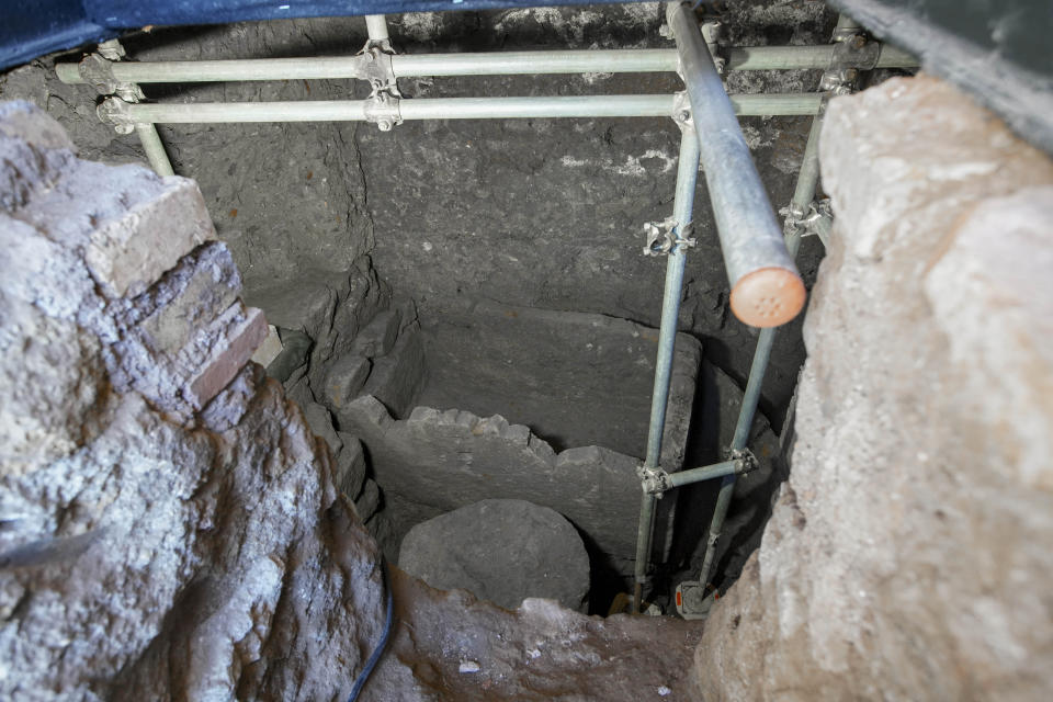 A 1.4-meter (55-inch) wide sarcophagus and what appears to be an altar, dating back to the 6th Century B.C., are seen in an underground chamber, at the ancient Roman Forum, during an unveiling to media, in Rome, Friday, Feb. 21, 2020. Archaeologists believe the underground shrine, who's finding was announced earlier this week, was dedicated to Romulus, the founder of the ancient city. (AP Photo/Andrew Medichini)