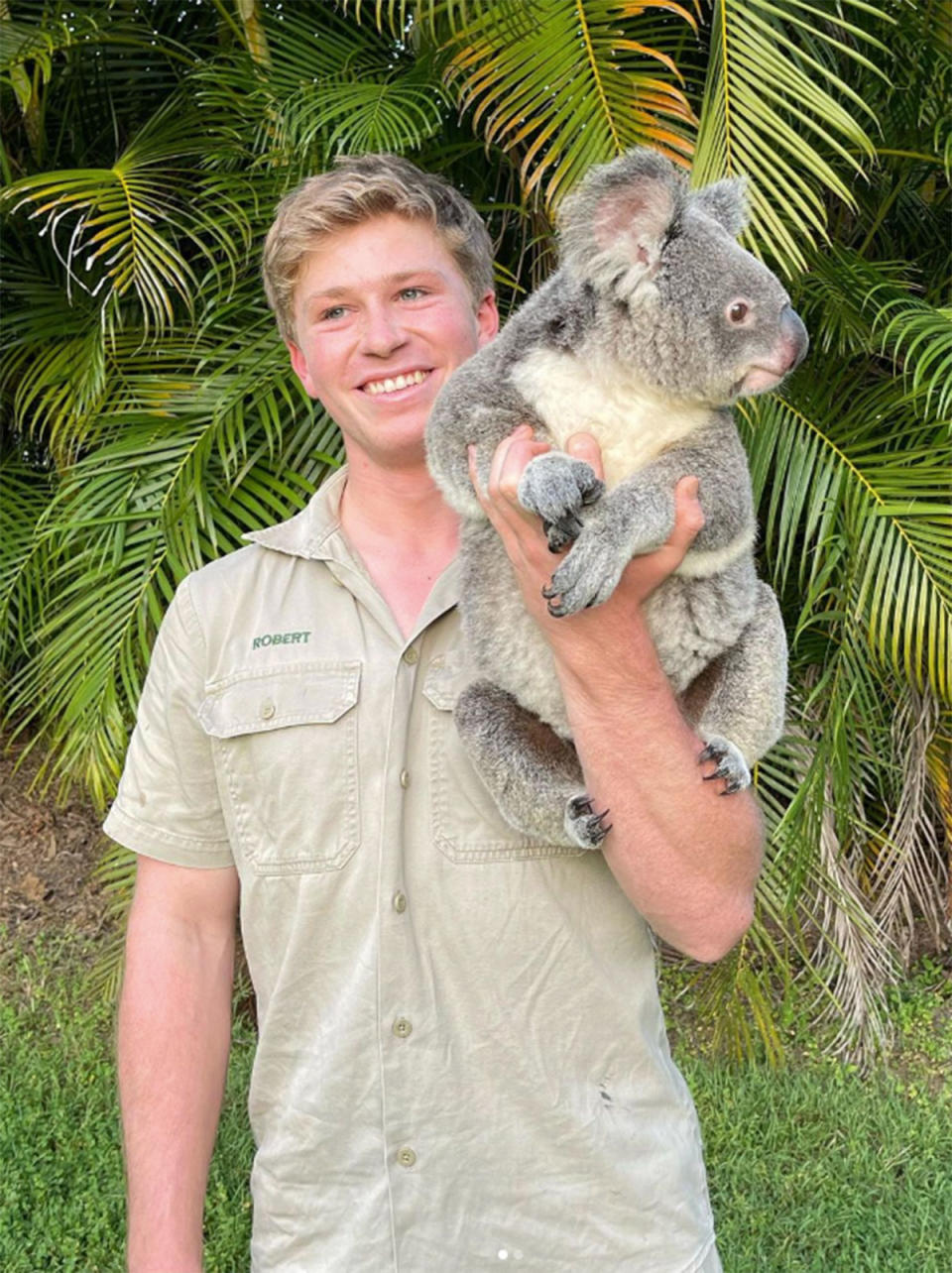 Robert Irwin holding a koala