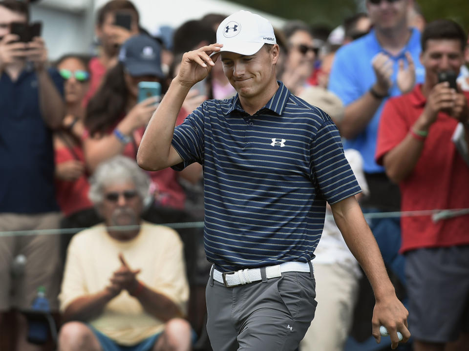 Jordan Spieth tips his hat to fans as he is introduced at the first hole during the final round of the Travelers Championship golf tournament, Sunday, June 25, 2017, in Cromwell, Conn. (AP Photo/Jessica Hill)