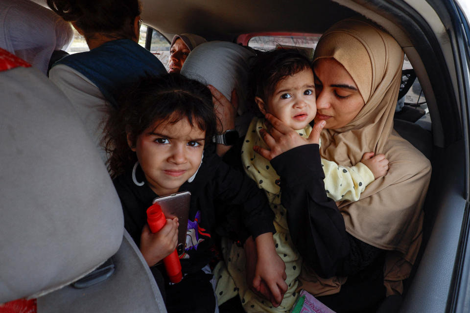 Raghda Abu Marasa, who fled after Israel called for more than 1 million civilians in the Gaza Strip to move south, with her children as they return to their home in Gaza City on Tuesday.