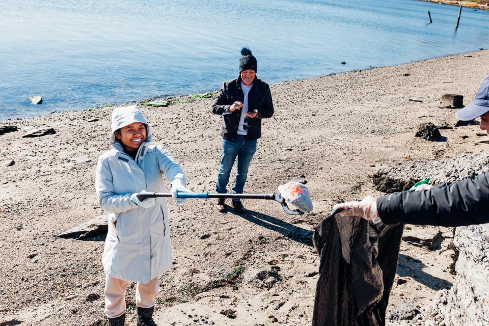 Volunteers help clean up an Aquidneck Island beach.