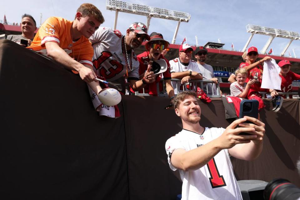 YouTuber and North Carolina native Jimmy Donaldson, also known as “MrBeast,” with fans before a football game at Raymond James Stadium. Nathan Ray Seebeck/USA TODAY Sports