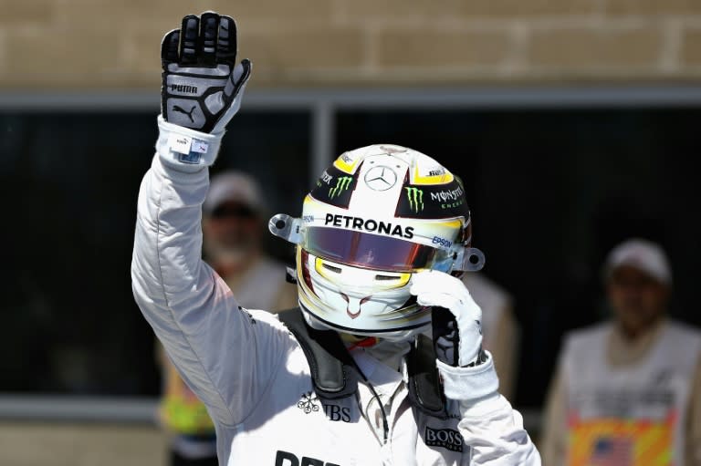 Lewis Hamilton of Great Britain and Mercedes GP waves to the crowd after qualifying in pole position during qualifying for the United States Formula One Grand Prix at Circuit of The Americas on October 22, 2016 in Austin, United States