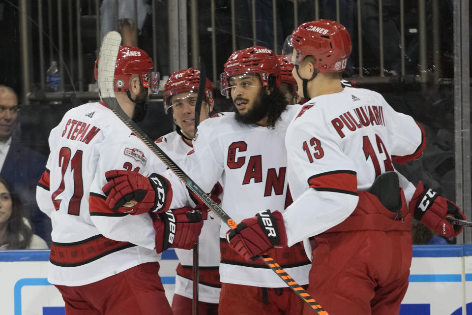 Carolina Hurricanes defenseman Jalen Chatfield (5) celebrates after scoring against the New York Rangers during the third period of an NHL hockey game Tuesday, March 21, 2023, at Madison Square Garden in New York. The Hurricanes won 3-2. (AP Photo/Mary Altaffer)