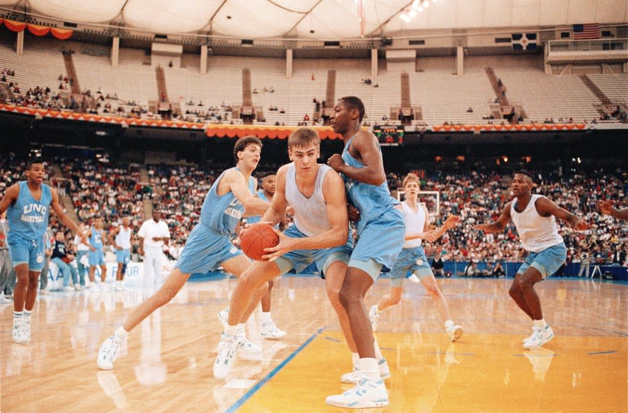 North Carolina’s Eric Montross drives on teammate George Lynch during practice at the Hoosier Dome in Indianapolis, IN., March 29, 1991. (AP Photo/Ed Reinke)