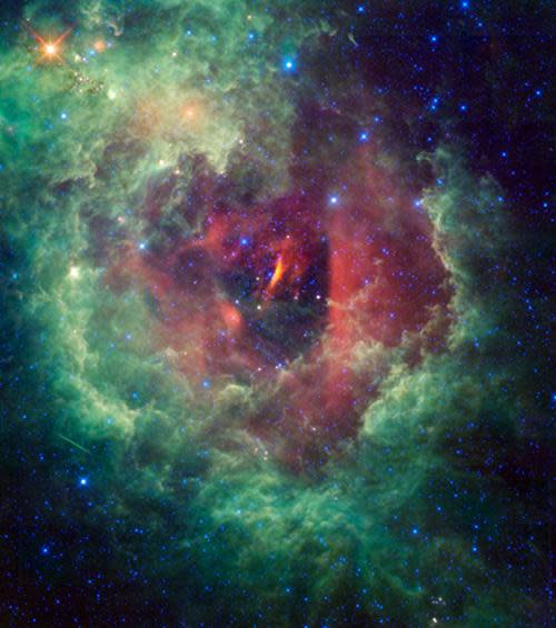 Photo by: NASA/JPL-Caltech/WISE Team<br>Rosette nebula-<br>This WISE image shows off the flower-shaped nebula, NGC 2237, also known as the rosette nebula. The nebula is a massive, star-forming cloud of gas and dust located within the constellation Monoceres, or the Unicorn.