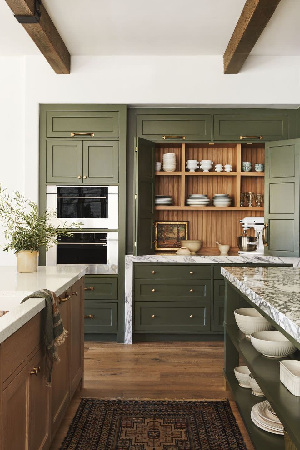 a kitchen with green cabinets