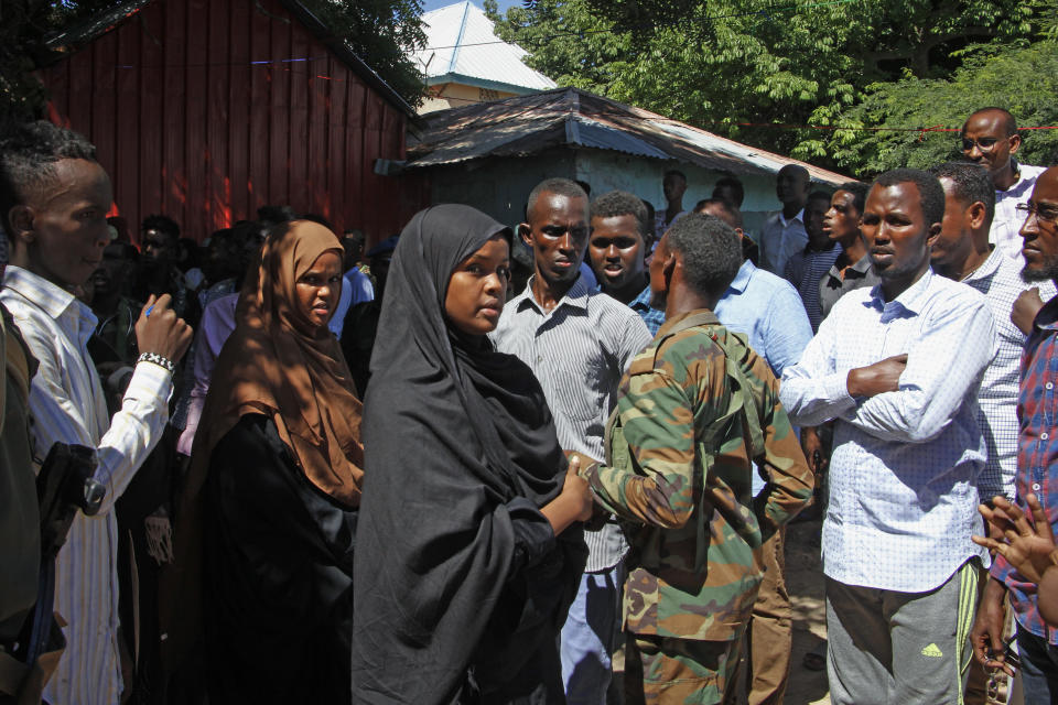 Ilwad Elman, center, who was reportedly shortlisted for this year's Nobel Peace Prize, attends the funeral service for her sister, Somali Canadian peace activist Almaas Elman, in the capital Mogadishu, Somalia Friday, Nov. 22, 2019. Preliminary investigations show Almaas Elman was killed by a stray bullet inside a heavily defended base near the international airport earlier this week in Mogadishu, the peacekeeping mission in Somalia said Friday. (AP Photo/Farah Abdi Warsameh)